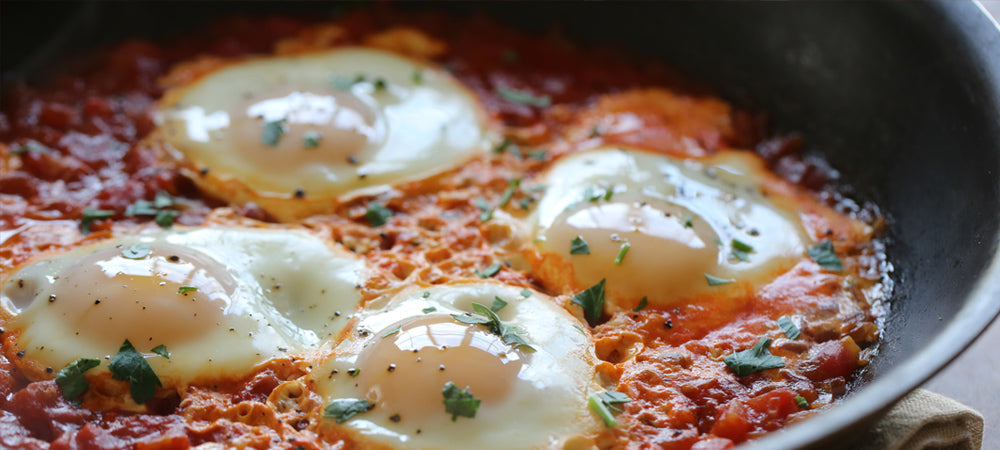 Shakshuka, a richly spiced tomato sauce that can be served on the skillet with poached eggs.